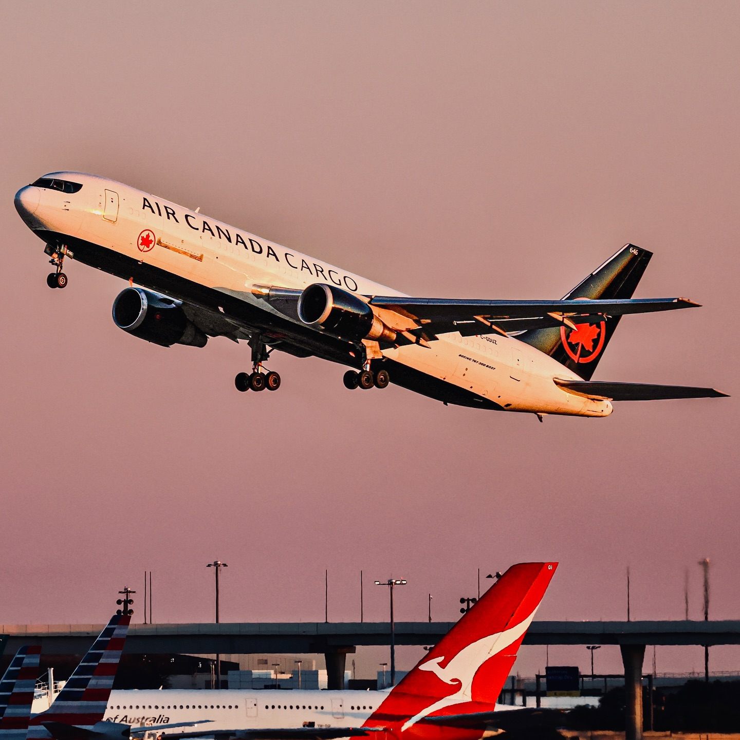 Two commercial aircraft moving on parallel paths near an airport